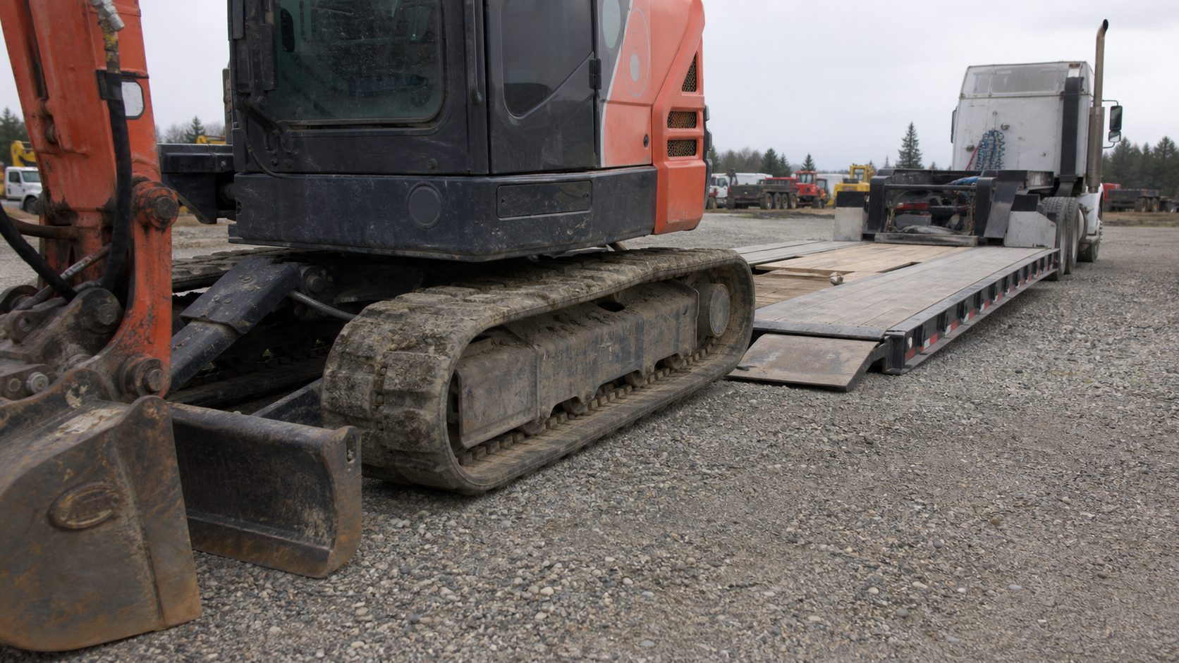 Bucket and boom position can affect fit for equipment hauling transport planning.